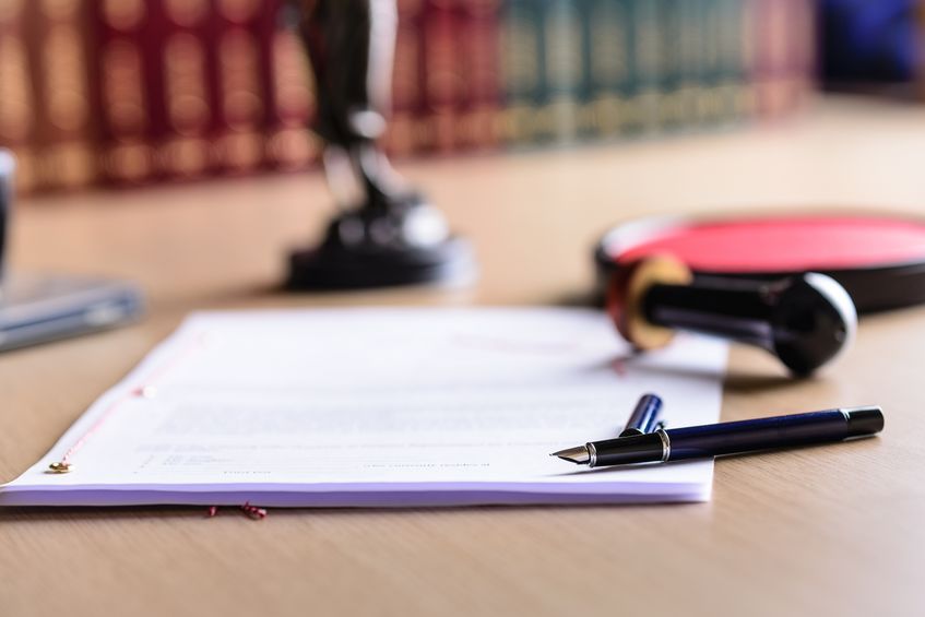 Contract waiting for a notary public sign on desk.